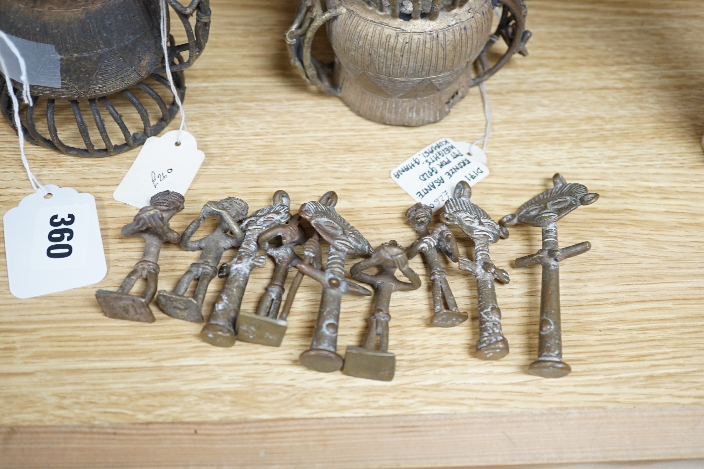 A collection of four Ashanti bronze figural vessels, and nine single figures, tallest 29cms high